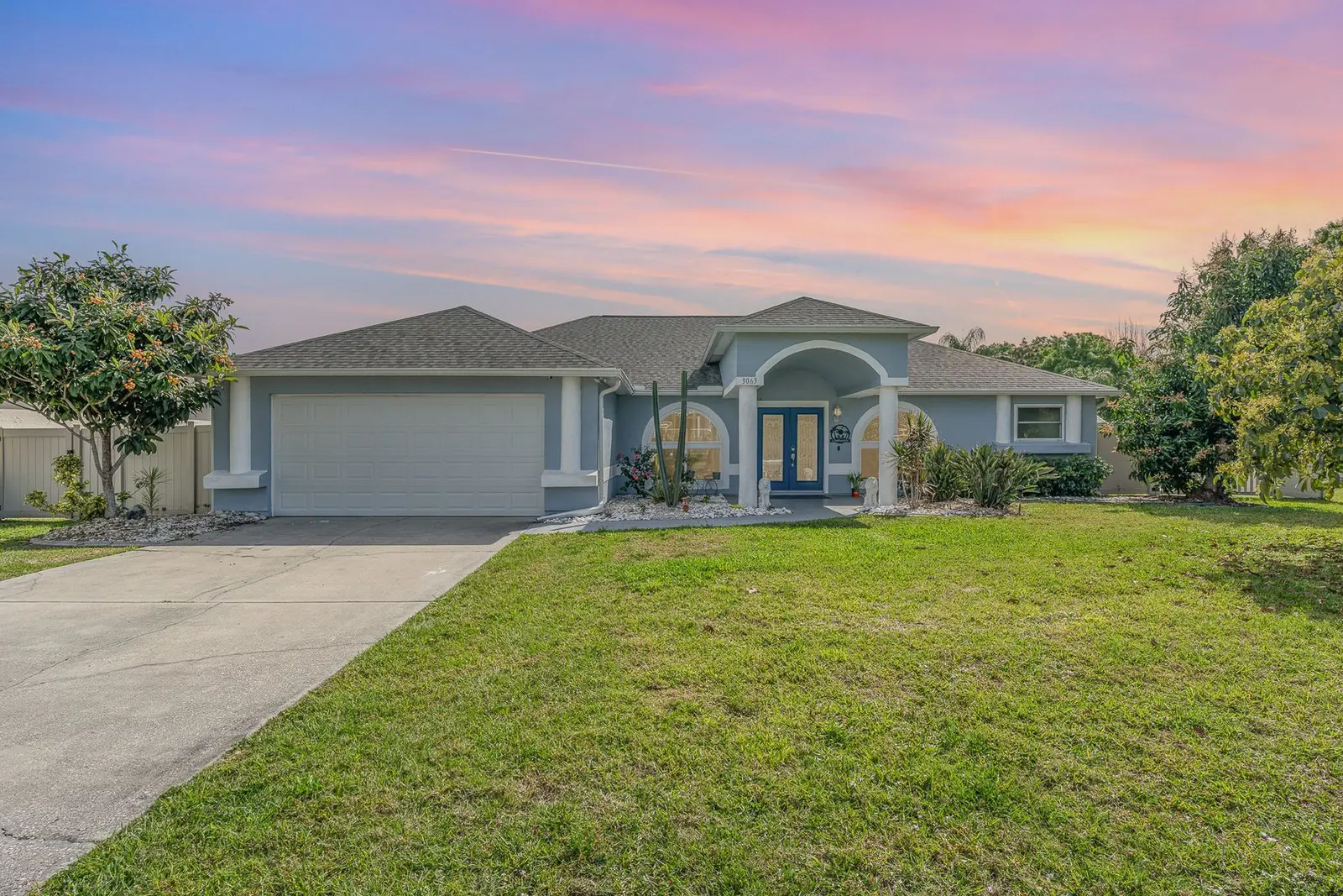 Single-story home with a wide green lawn